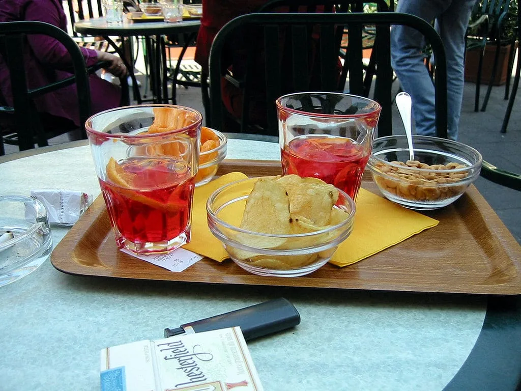 Campari Soda: Campari with a splash of soda water, ice cubes and orange slice.