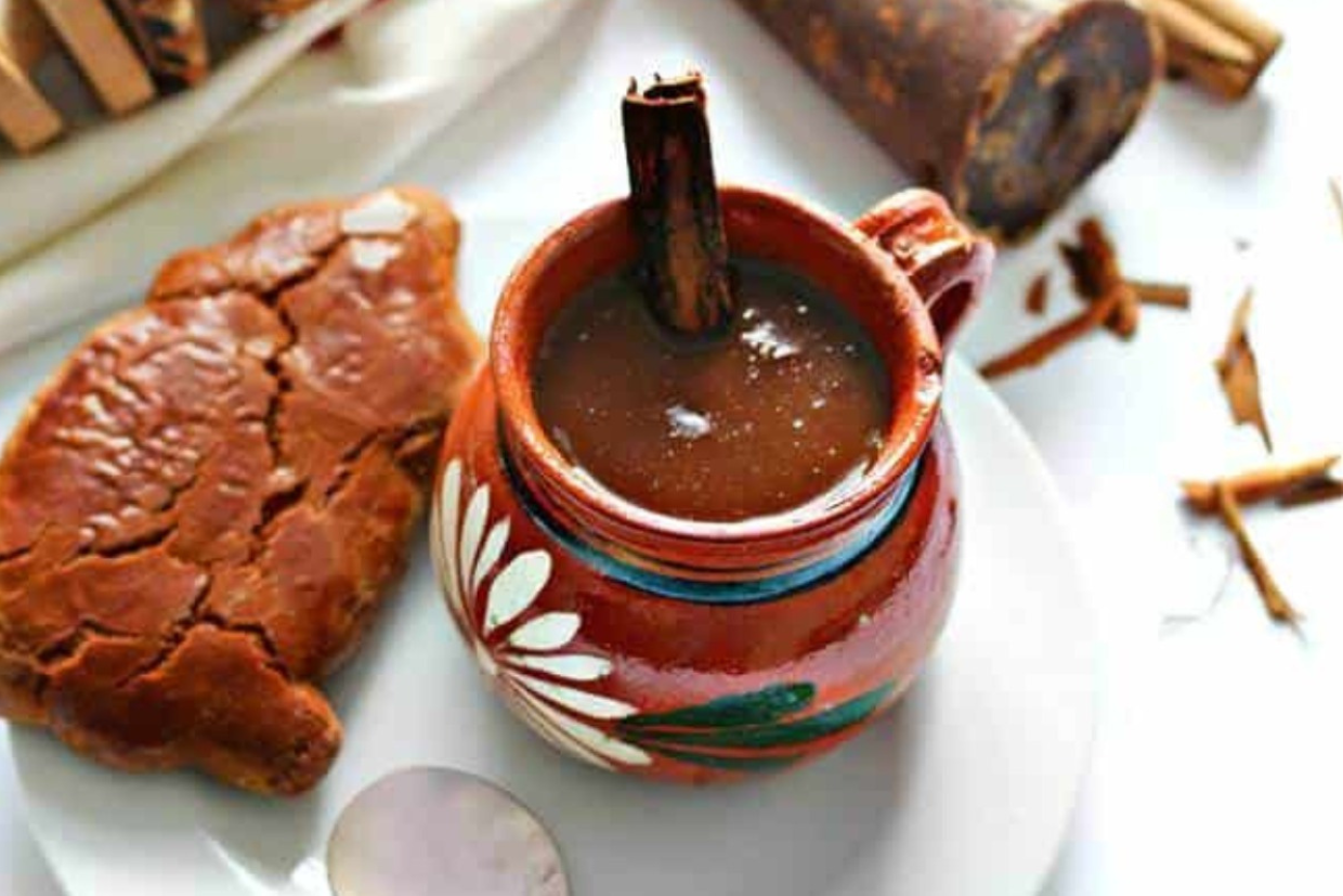 Warm champurrado in a traditional clay mug